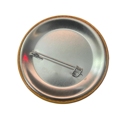 Metallic button badge with a pin on a white background